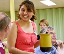 Knox student Maricruz Osorio '14 chats with KPCK diners as she serves beverages.