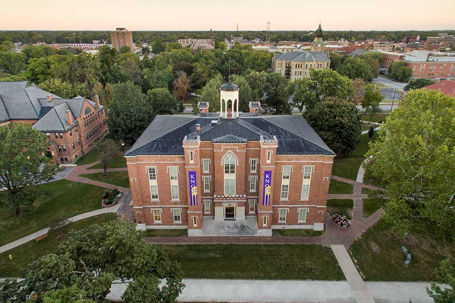 Old Main, viewed from above, with the city of Galesburg in the background