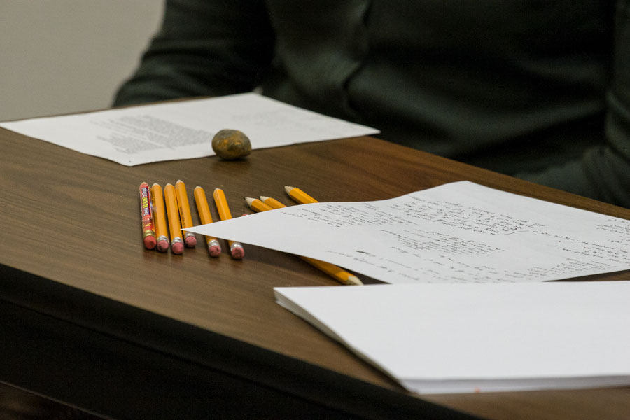 Papers and pencils on desk.