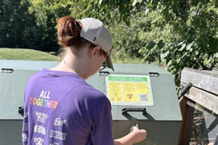 a student accesses the Knox compost station