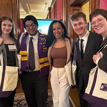 A group of Knox alumni and friends take a photo with their Venture Boldly swag.