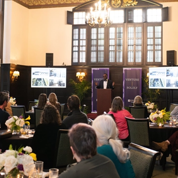 A group of Knox alumni and friends listen as President C. Andrew McGadney speaks