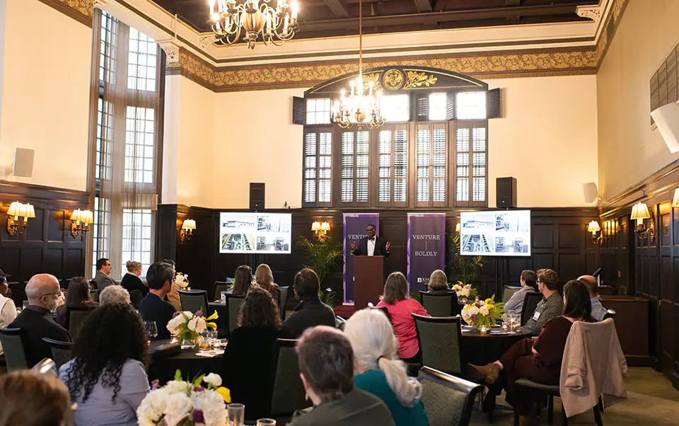 Event attendees focus their attention on President C. Andrew McGadney as he speaks from the stage.