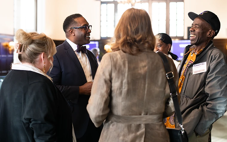 President C. Andrew McGadney talks and laughs with event attendees.